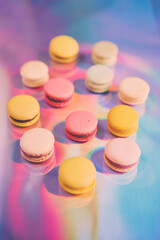 Obraz na płótnie Canvas French cake macaron. Set of cute sweets on colorful rainbow background. almond cookies, pastel colors, top view