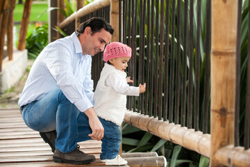 Beautiful baby girl having fun outdoors with her father . Fatherhood concept. Happiness concept. Family concept