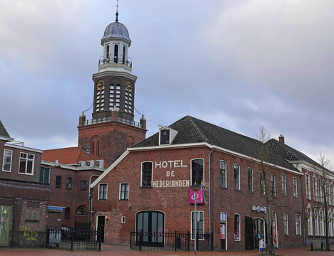 Winschoten, Netherlands - Jan 30 2023 In the front 'Hotel De Nederlanden'. This historic hotel closed its doors after 140 years. Behind it you can see the famous tower of Winschoten, D'Olle Witte