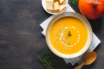 Roasted pumpkin and carrot soup with pumpkin  and hemp seeds. Pumpkin traditional soup with creamy silky texture.