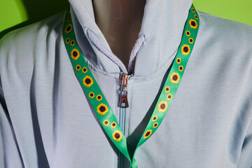 Sunflower lanyard, symbol of people with invisible or hidden disabilities.