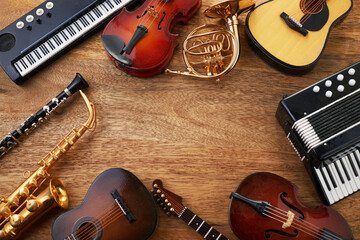Frame of different musical instruments on wooden background