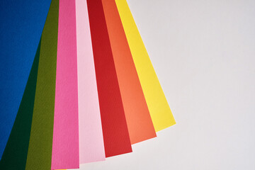 Abstract texture of colored paper. Geometric shapes and lines in bright colors. Place for text. Multicolor abstract flat lay. Back to school concept. Copy space, top view