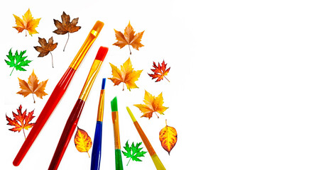 artistic pain brushes of various colors with autumn leaves like romantic autumn jolly art background with copy space 