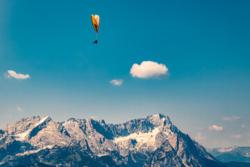 Alpine summer view with a paraglider at Mount Wank, Garmisch-Partenkirchen, Bavaria, Germany