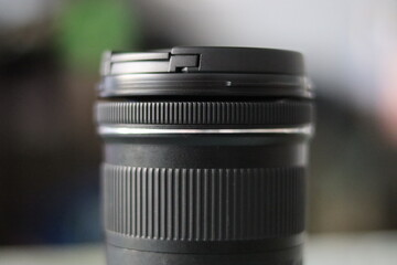 Fototapeta na wymiar Closeup Of DSLR zoom lens in a bokeh and selective focus background 