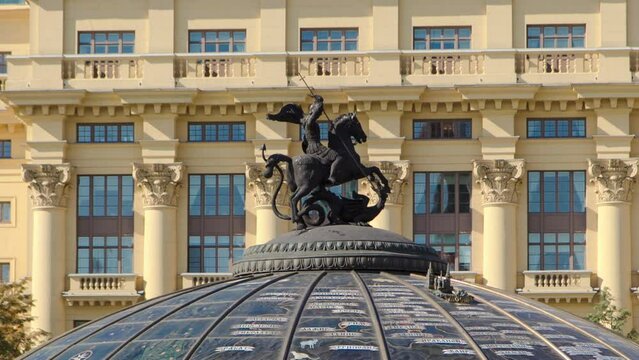 Glass cupola crowned by a statue of Saint George, patron of Moscow, at the Manege Square timelapse hyperlapse in Moscow, Russia. Historic buildings on a background. Close up view