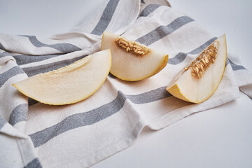 Slices of juicy melon on a light background. Organic summer fruits. The concept of food, health, nutrition
