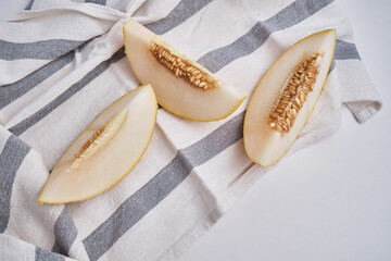 Slices of juicy melon on a light background. Organic summer fruits. The concept of food, health, nutrition
