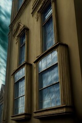 Obraz premium A Tall Building With Two Windows And A Cloudy Sky