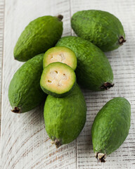 Ripe green feijoa on a light wooden table. Fruit.