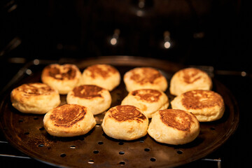 Fresh baked cheesecakes. Cottage cheese pancakes or curd fritters on a baking sheet. Healthy and diet breakfast at morning