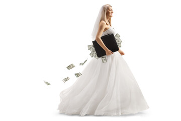 Full length profile shot of a bride walking with a briefcase full of money