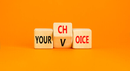 Your voice choice symbol. Businessman turns wooden cubes and changes the concept word Your choice to voice. Beautiful orange table orange background, copy space. Business and your voice choice concept