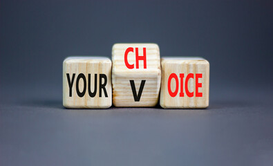 Your voice choice symbol. Businessman turns wooden cubes and changes the concept word Your choice to voice. Beautiful grey table grey background, copy space. Business and your voice choice concept - obrazy, fototapety, plakaty