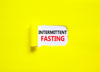 Intermittent fasting symbol. Concept words Intermittent fasting on beautiful white paper. Beautiful yellow background. Healthy lifestyle intermittent fasting concept. Copy space.