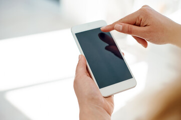 Shes always been well connected in the business world. Cropped shot of an unrecognizable businesswoman using her smartphone inside of an office.