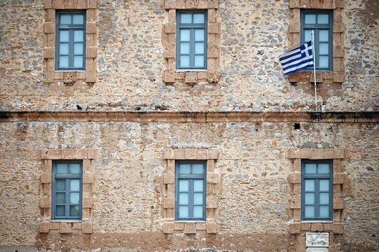 an old stone building with a Greek flag, Syntagma Square, Nafplio