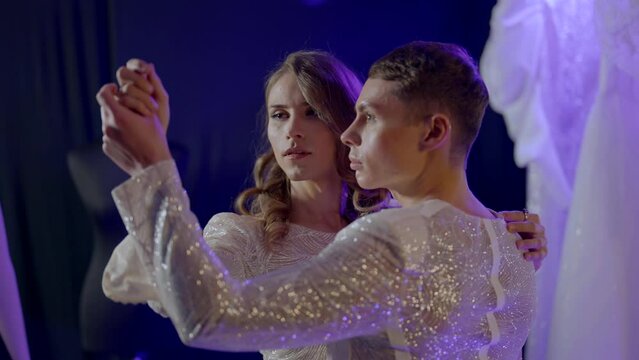 loving couple of gays dancing in dark studio, romantic date of homosexual pair, lgbt community