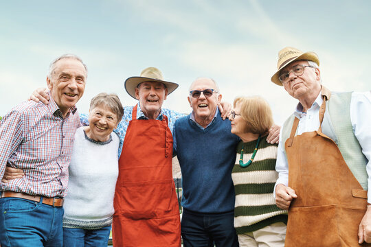 Joyful Senior Friends Embracing Outdoors - Lively seniors arm-in-arm sharing a laughter.