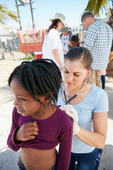 We all need access to medical care. Shot of a volunteer nurse examining a young patient with a stethoscope at a charity event.