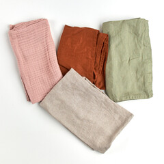 Napkins and towels on white background. Kitchen textiles, top view