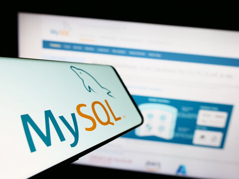 Stuttgart, Germany - 07-13-2023: Smartphone with logo of relational database management system MySQL on screen in front of website. Focus on center of phone display.