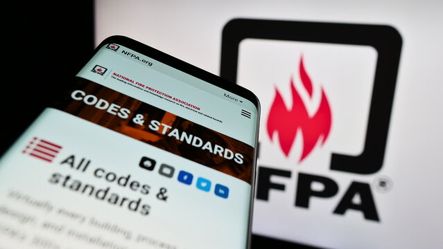 Stuttgart, Germany - 07-13-2023: Mobile phone with website of National Fire Protection Association (NFPA) on screen in front of logo. Focus on top-left of phone display.