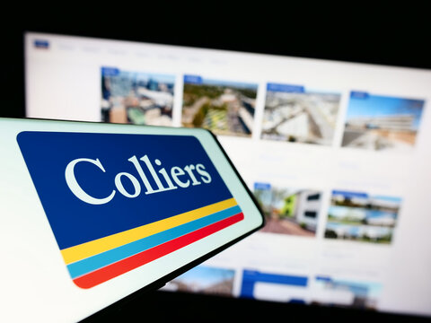 Stuttgart, Germany - 07-14-2023: Mobile phone with logo of company Colliers International Group Inc. on screen in front of business website. Focus on center-left of phone display.