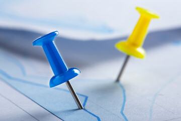 Marking financial chart by pins.Share listing and checking financial chart. Concept of banking, financial report and financial audit.