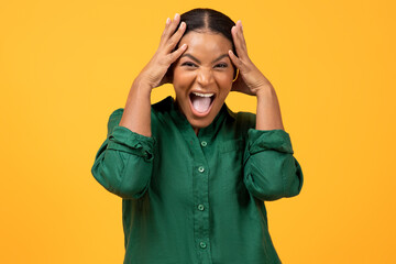 Emotional Black Woman Shouting Touching Head Standing On Yellow Background