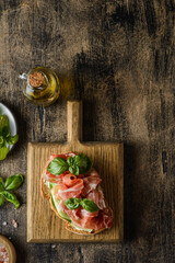 bruschetta with jamon on a dark wooden background