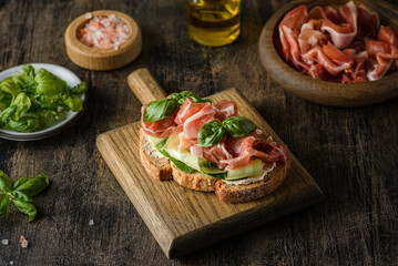 bruschetta with jamon on a dark wooden background