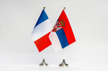 State flags of France and Serbia on a light background.