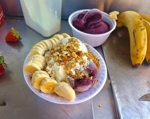 Acai bowl with banana, strawberry and condensed milk. Brazilian food