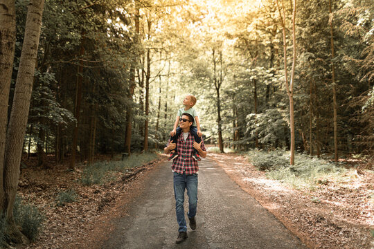 Father and son enjoying a nature walk hike in the forest - Powered by Adobe