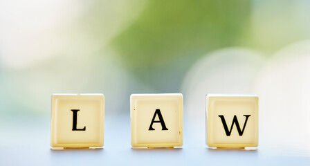 Law letter, and table with block cubes in outdoor blur with mock up space for justice or attorney. Legal, alphabet and questions for support or services in brokeh background with regulation for help.
