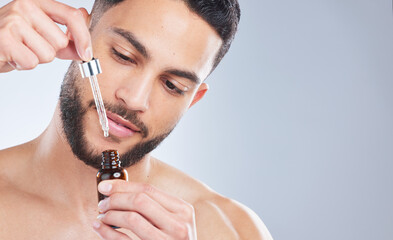 Mockup, serum and man with skincare, cosmetics and dermatology against a grey studio background....