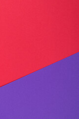 Multicolor background from a paper of different colors. Mix of red and purple colors. Geometric backdrop.