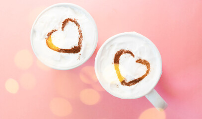 Hearts shapes on Two cups of coffee top view. Valentine's day greeting. Festive glowing