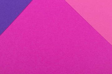 Multicolor background from a paper of different colors. Mix of pink and purple colors. Geometric backdrop.