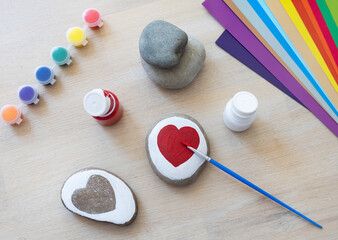 Heart painted on stone. Handcraft, handmade activities.Kid's artwork. Child's drawing. Preschool art natural design.