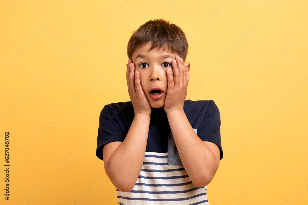 Wall mural scared boy frightened and amazed with open mouth