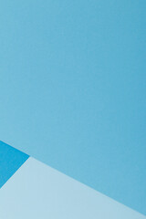 Multicolor background from a paper of different shades of blue. Geometric backdrop.