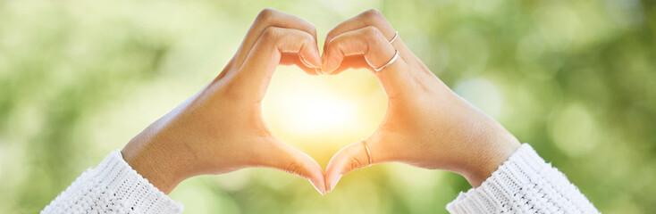 Love, heart and lens flare with hands of woman in nature for support, motivation and kindness....