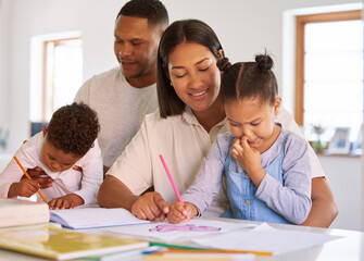 Fototapeta premium Family, parents help their children with homework and books on desk at their home. Support with writing or reading, education or learning and woman with man helping their kids color in a book