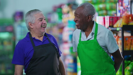 Happy diverse senior workers standing at grocery store smiling at camera wearing uniforms. Older Brazilian staff workers