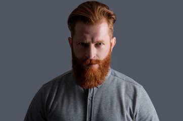 Portrait of bearded man. Irish man with red beard and moustache. Unshaven man with serious face