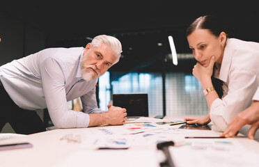 Businesswoman and senior colleague discussing strategy in office