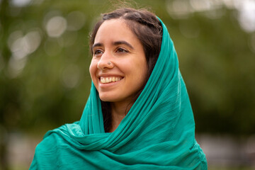 Close up smiling young woman with green head scarf